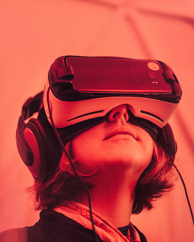 Red tinted image showing a woman with a VR set